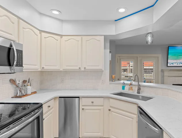 a kitchen with stainless steel appliances white cabinets and a sink