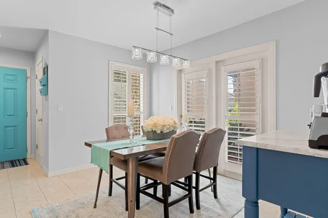 a dining room with furniture and window