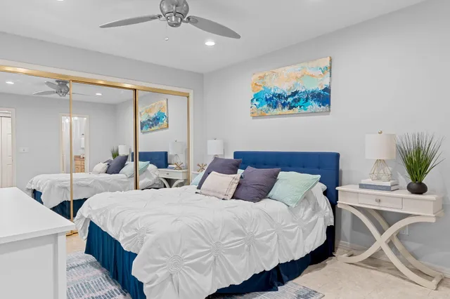 a bedroom with double bed and a potted plant