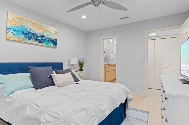 a bedroom with a bed and a painting on the wall