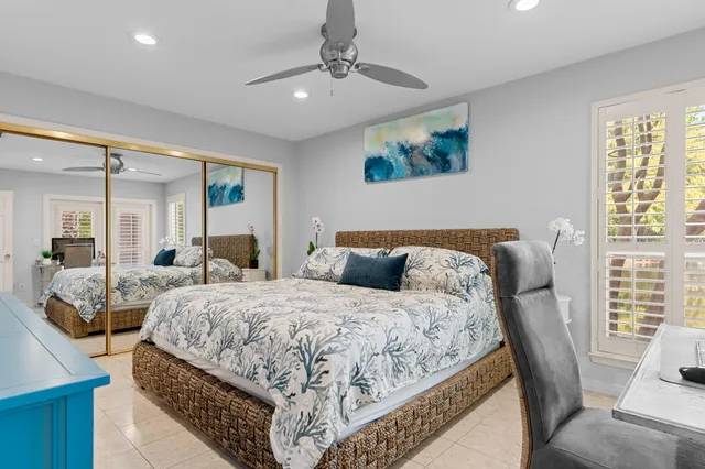 a bedroom with bed and glass door