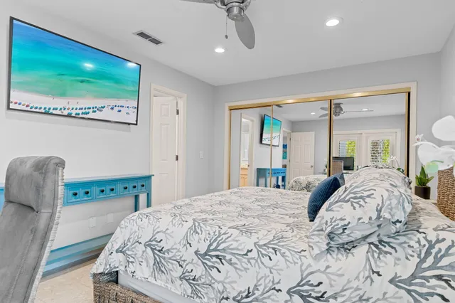 a bedroom with a bed and a large window