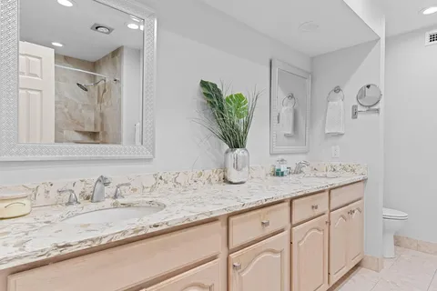 a bathroom with a granite countertop sink mirror and vanity