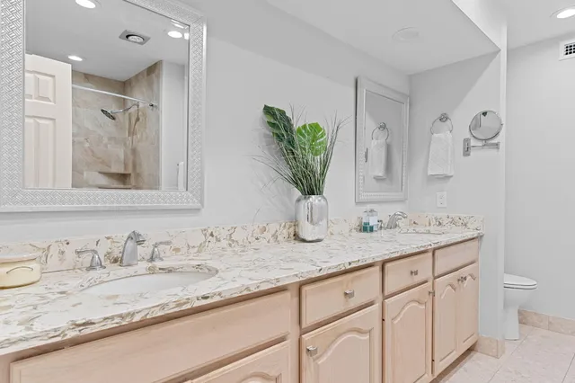 a bathroom with a granite countertop sink mirror and vanity