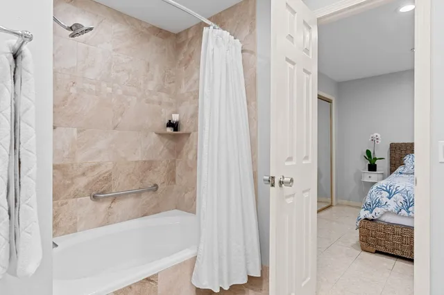 a bathroom with a bathtub and shower