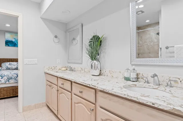 a bathroom with a granite countertop sink and a mirror