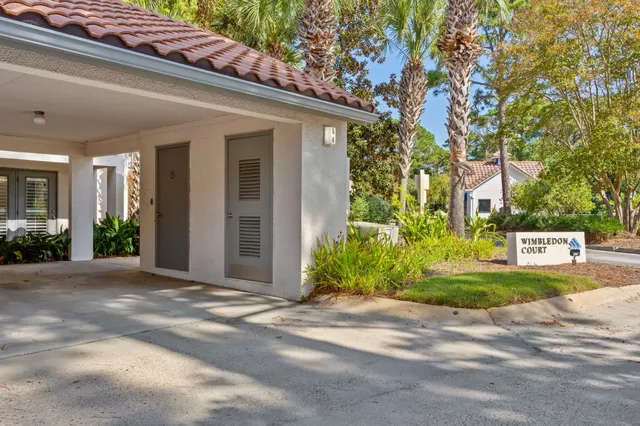 a front view of a house with a yard and potted plants