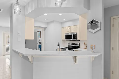 a kitchen with stainless steel appliances a sink and a refrigerator