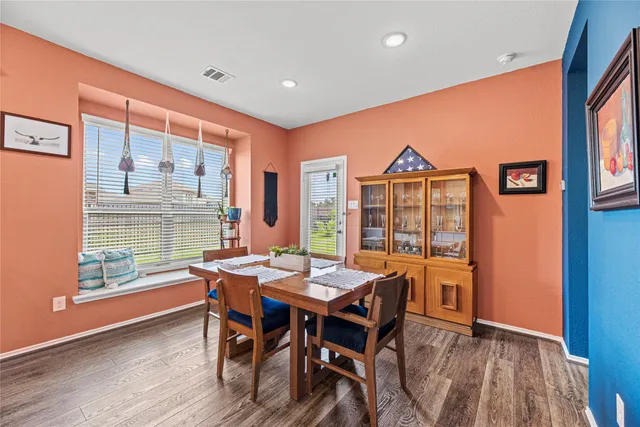 a view of a dining room with furniture window and wooden floor