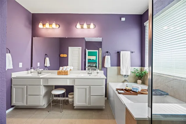 a kitchen with a sink and chairs