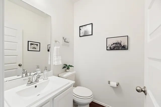a bathroom with a sink mirror and toilet
