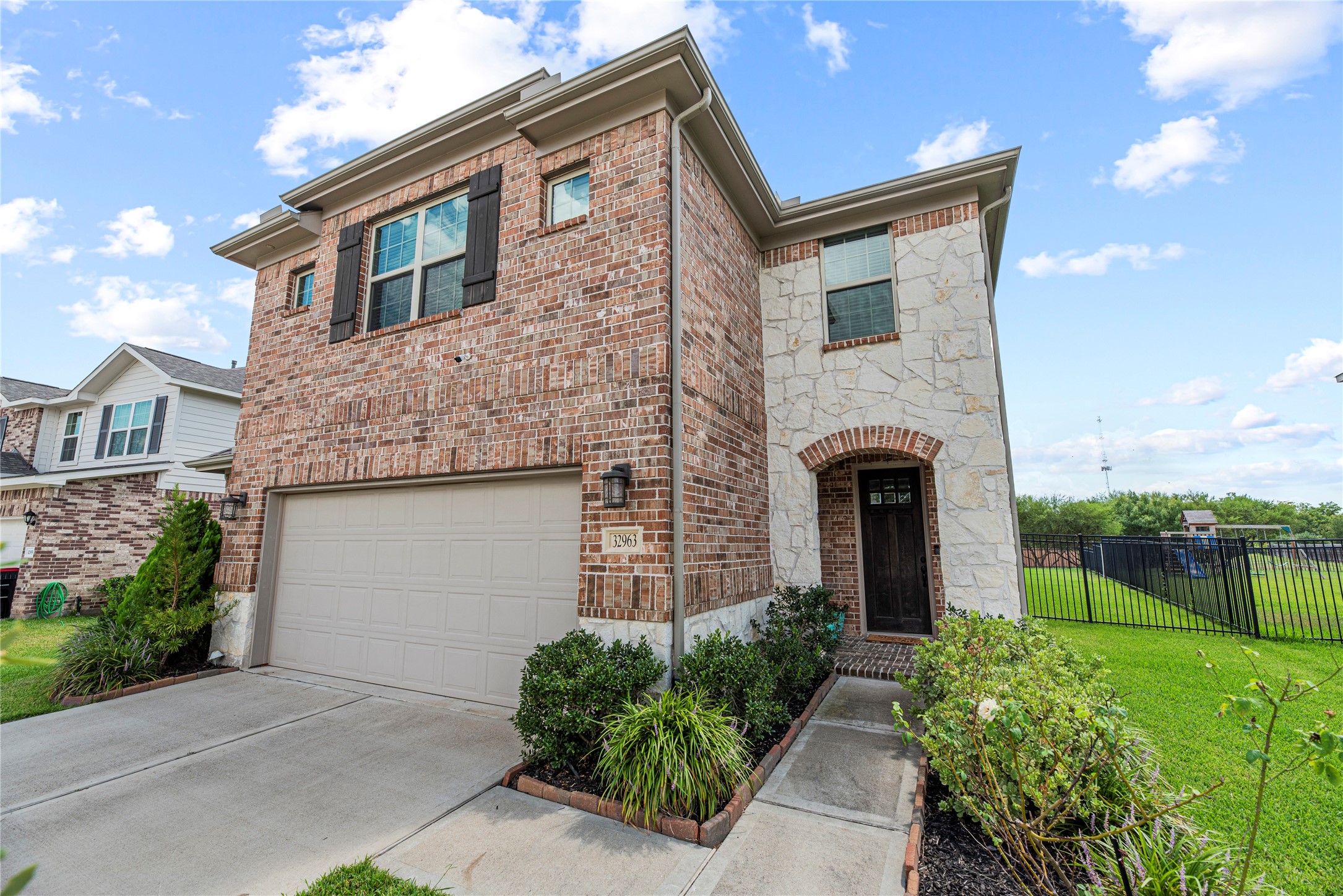 32963 Ruthie Dean Drive Fulshear, TX 77423 - Photo 2 of 45 a front view of house with yard and green space