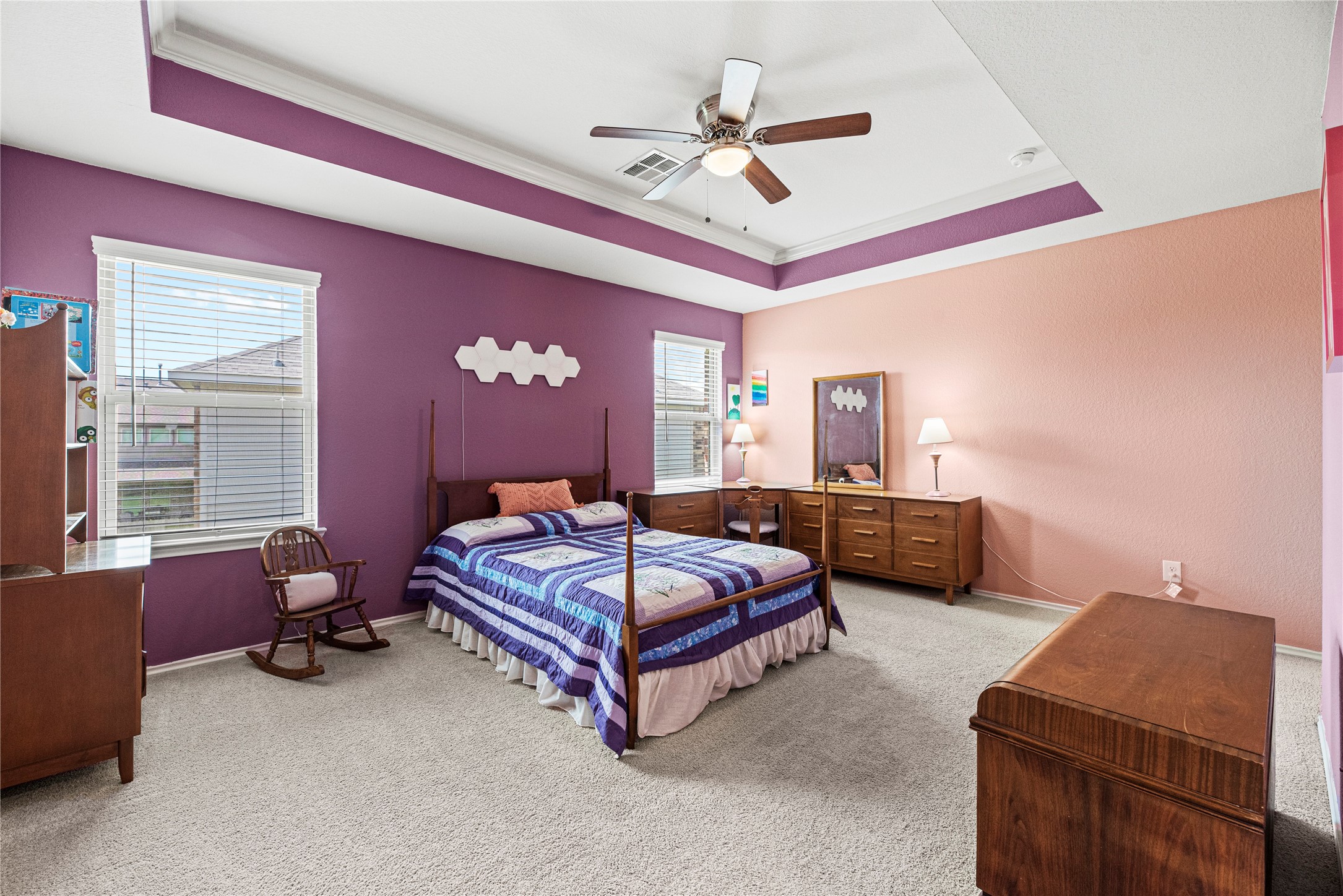 32963 Ruthie Dean Drive Fulshear, TX 77423 - Photo 23 of 45 a spacious bedroom with a bed and a chandelier