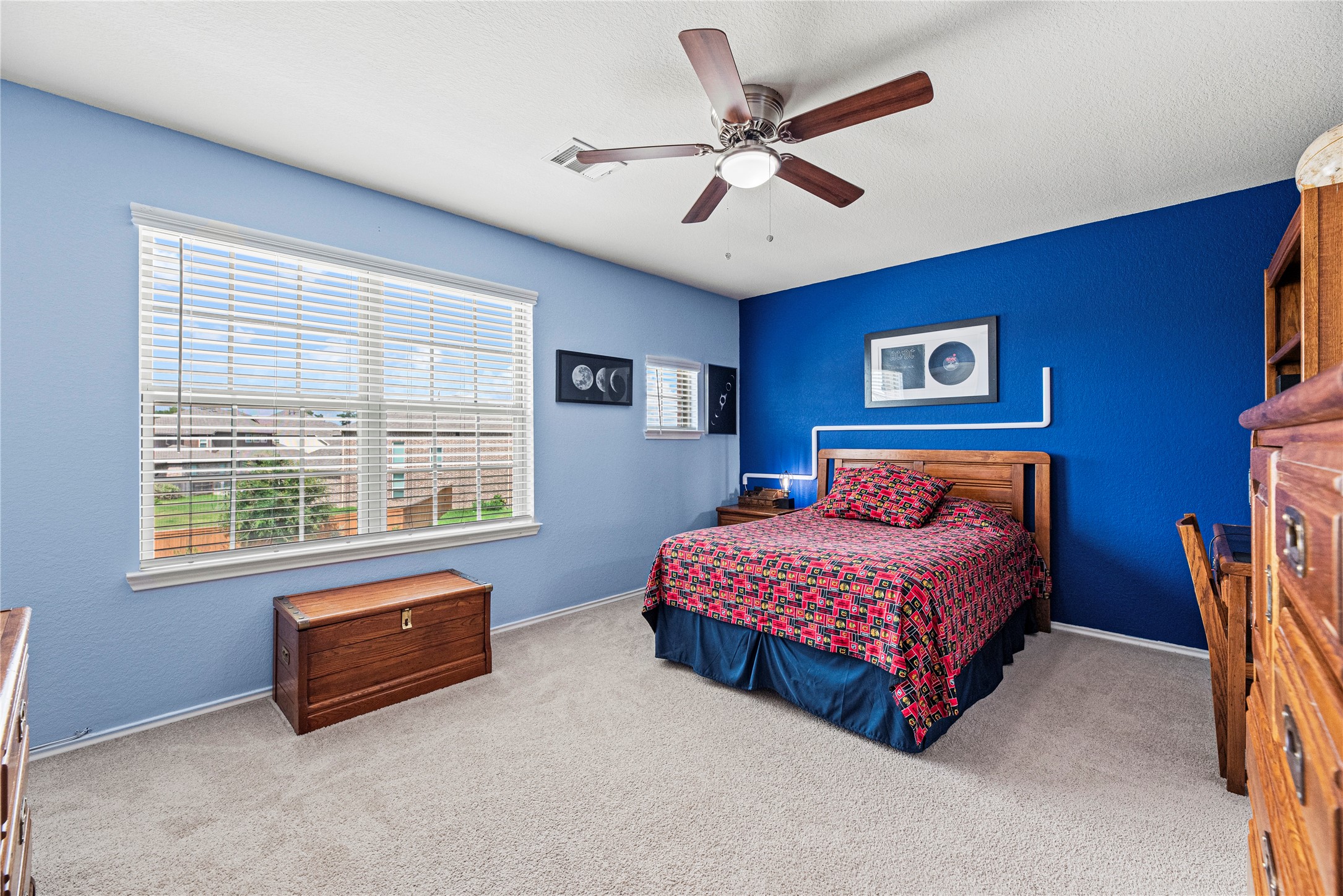 32963 Ruthie Dean Drive Fulshear, TX 77423 - Photo 30 of 45 a spacious bedroom with a bed and a large window