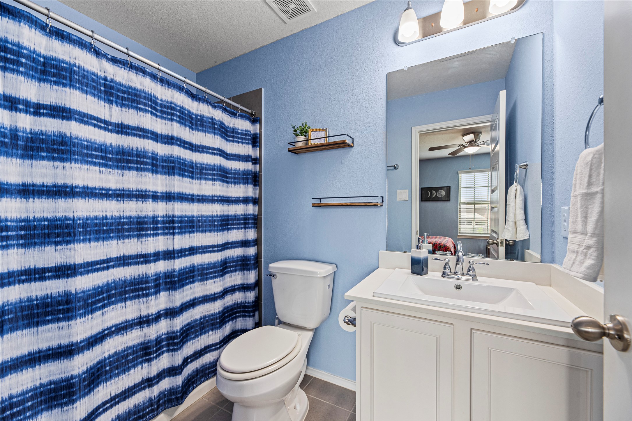 32963 Ruthie Dean Drive Fulshear, TX 77423 - Photo 31 of 45 a bathroom with a sink a toilet and shower curtain