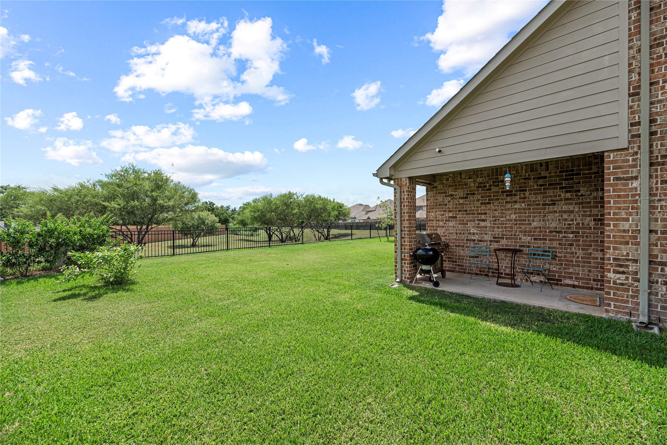 32963 Ruthie Dean Drive Fulshear, TX 77423 - Photo 35 of 45 a view of a backyard with table and chairs and a tree