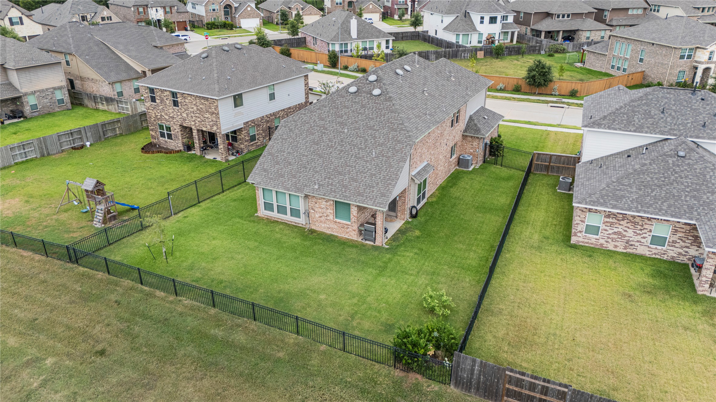 32963 Ruthie Dean Drive Fulshear, TX 77423 - Photo 42 of 45 a aerial view of a house with swimming pool lawn chairs and a yard