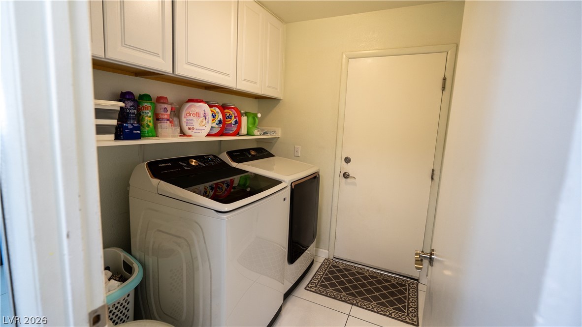 6429 Winding Ridge Las Vegas, NV 89156 - Photo 14 of 16 Functional laundry space featuring modern appliances and convenient overhead storage.