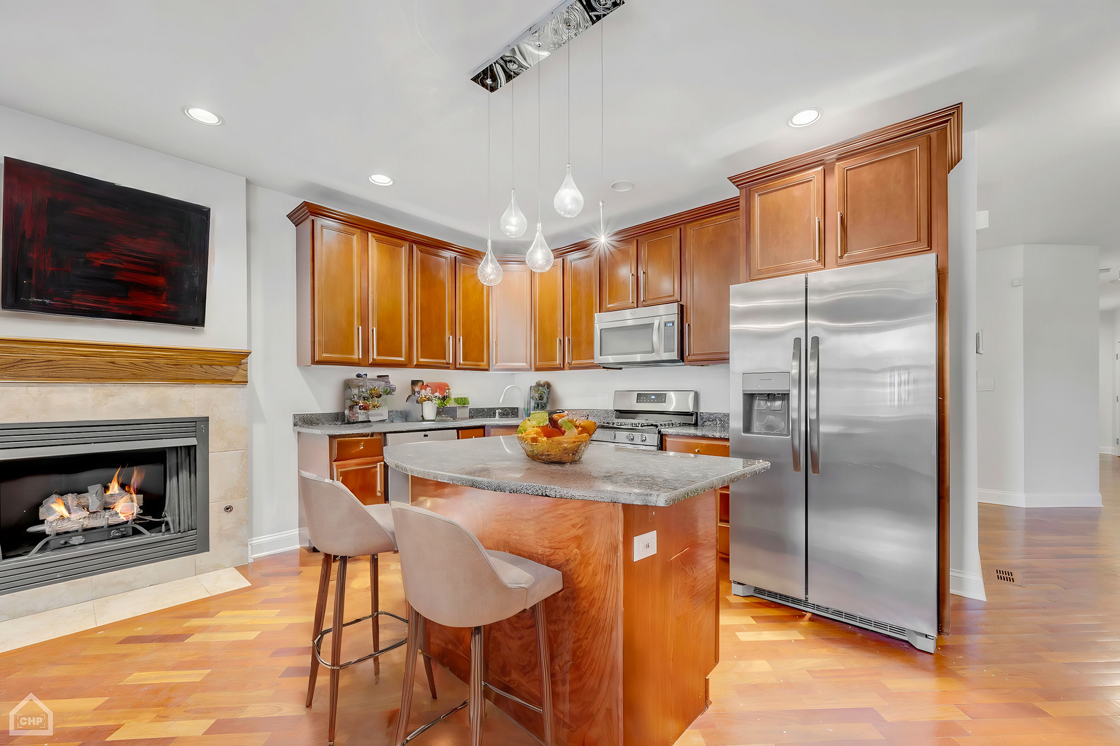 4235 South Calumet Avenue Chicago, IL 60653 - Photo 19 of 47 a kitchen with stainless steel appliances granite countertop a refrigerator a stove a sink a dining table and chairs with wooden floor