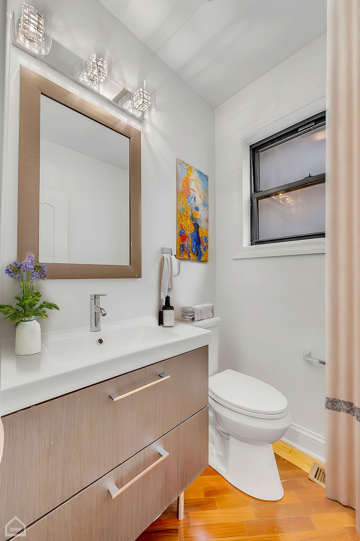 4235 South Calumet Avenue Chicago, IL 60653 - Photo 22 of 47 a bathroom with a toilet sink and mirror
