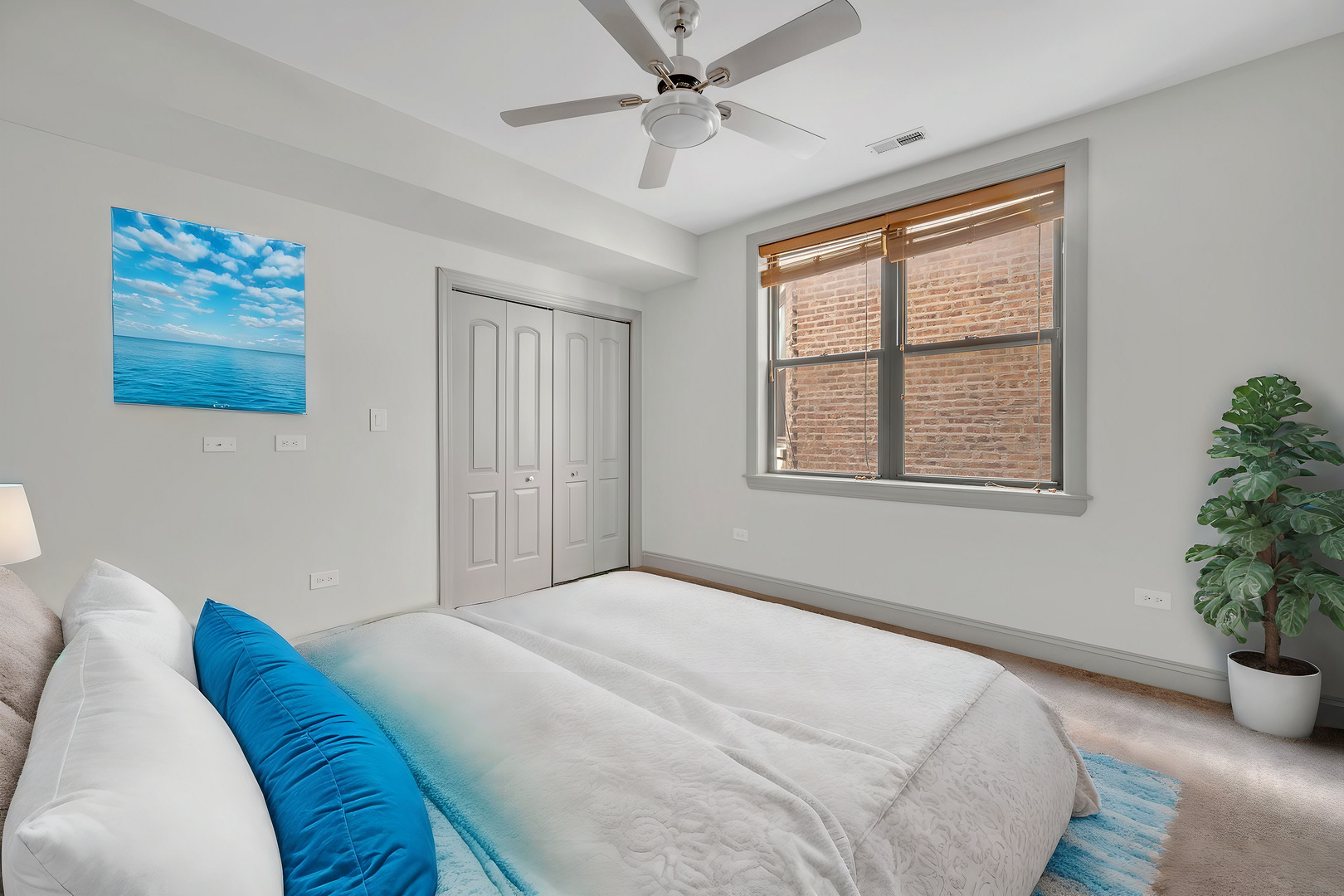 4235 South Calumet Avenue Chicago, IL 60653 - Photo 31 of 47 a bedroom with a bed and a potted plant