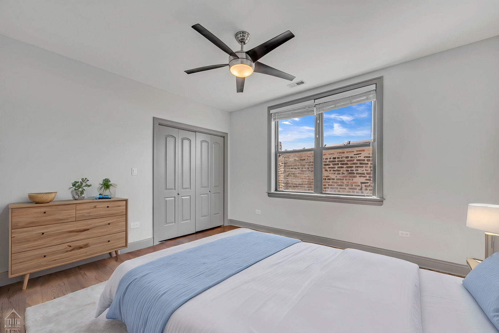 4235 South Calumet Avenue Chicago, IL 60653 - Photo 40 of 47 a bedroom with a large bed and a ceiling fan