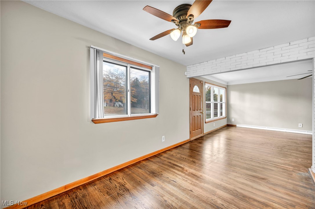 10927 Granger Road Cleveland, OH 44125 - Photo 16 of 33 Spare room featuring ceiling fan and wood finished floors