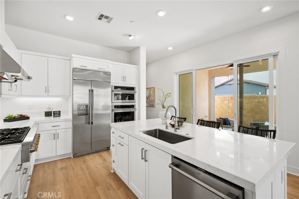 113 Bosal Irvine, CA 92618 - Photo 12 of 63 a kitchen with refrigerator a stove and cabinets