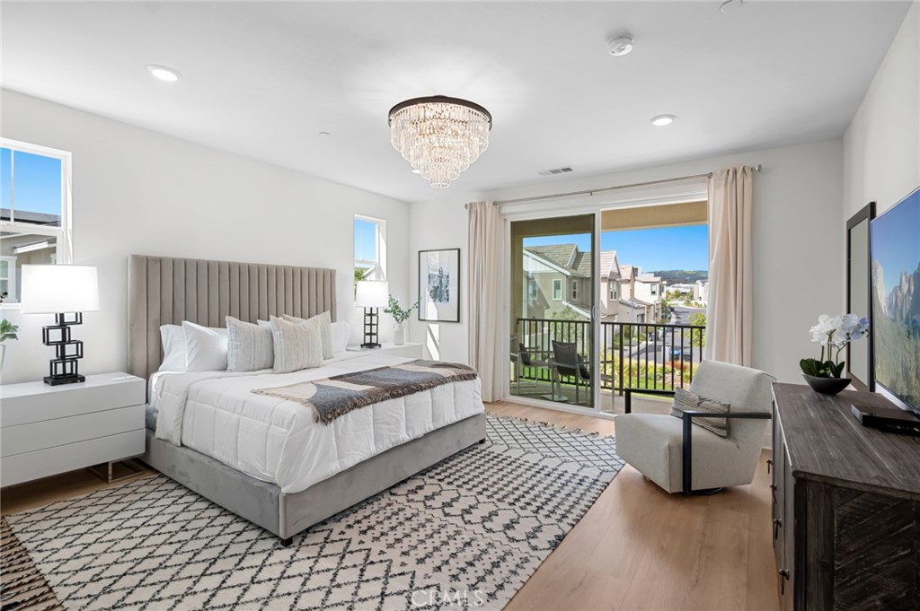 113 Bosal Irvine, CA 92618 - Photo 20 of 63 a spacious bedroom with a bed a chandelier and a large window
