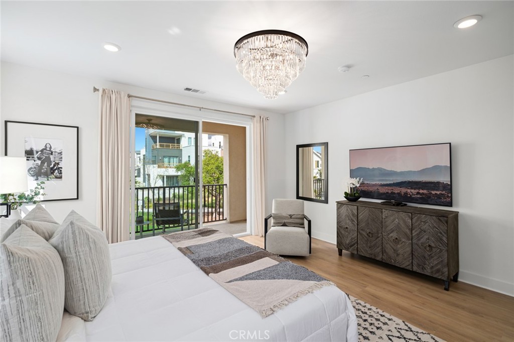 113 Bosal Irvine, CA 92618 - Photo 21 of 63 a spacious bedroom with a bed a table and chair