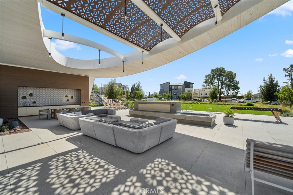 113 Bosal Irvine, CA 92618 - Photo 53 of 63 a living room with patio furniture and a garden