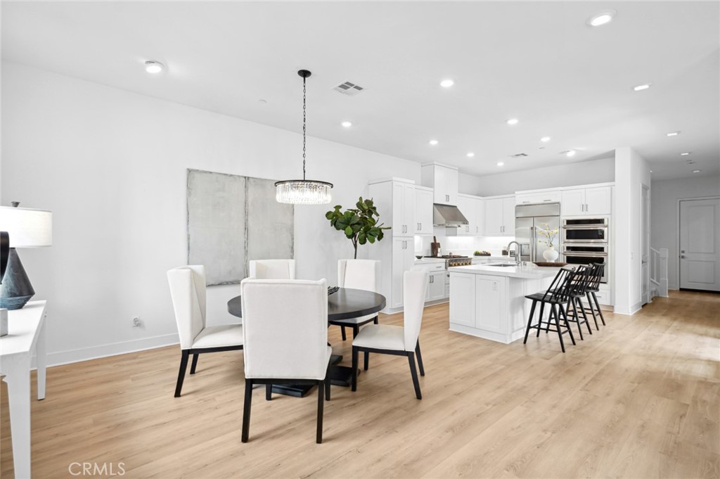 113 Bosal Irvine, CA 92618 - Photo 7 of 63 a view of a dining room with furniture and wooden floor