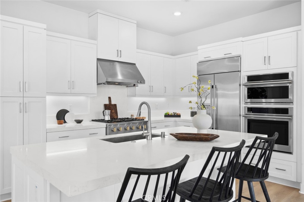 113 Bosal Irvine, CA 92618 - Photo 10 of 63 a kitchen with stainless steel appliances a microwave a sink a stove a table and chairs