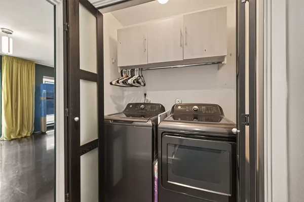 a bathroom with a granite countertop sink a mirror and a toilet