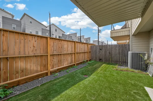 a view of a backyard with wooden fence