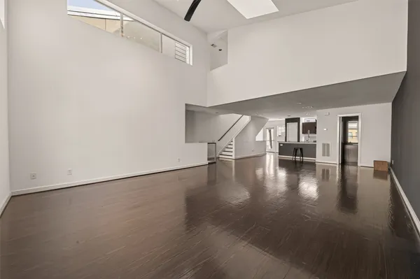 a view of a hallway with wooden floor and dining room
