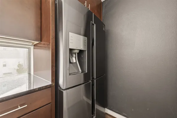 a close view of kitchen with a refrigerator