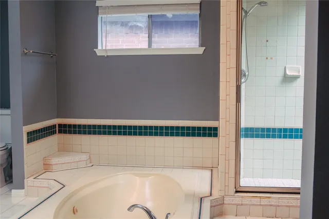a bathroom with a bathtub and a shower