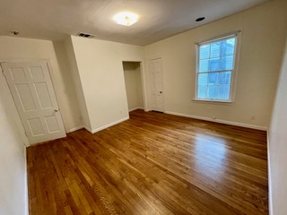 1305 East 28th Street, Unit A Austin, TX 78722 - Photo 12 of 15 Unfurnished bedroom with wood finished floors and a closet