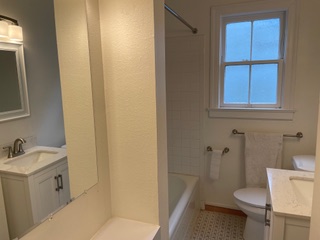 1305 East 28th Street, Unit A Austin, TX 78722 - Photo 14 of 15 Full bath featuring vanity, shower / bathtub combination, and light floors