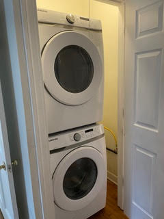 1305 East 28th Street, Unit A Austin, TX 78722 - Photo 15 of 15 Washroom with stacked washer / dryer and dark wood-style floors