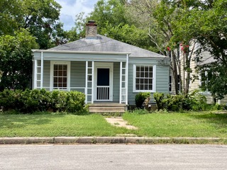 1305 East 28th Street, Unit A Austin, TX 78722 - Photo 2 of 15 Bungalow-style house featuring covered porch, a front lawn, and a chimney