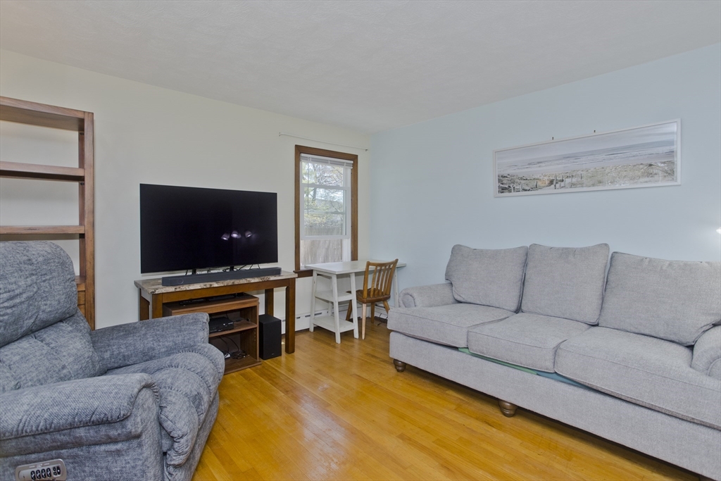460 James Street Chicopee, MA 01020 - Photo 16 of 34 a living room with furniture and a flat screen tv