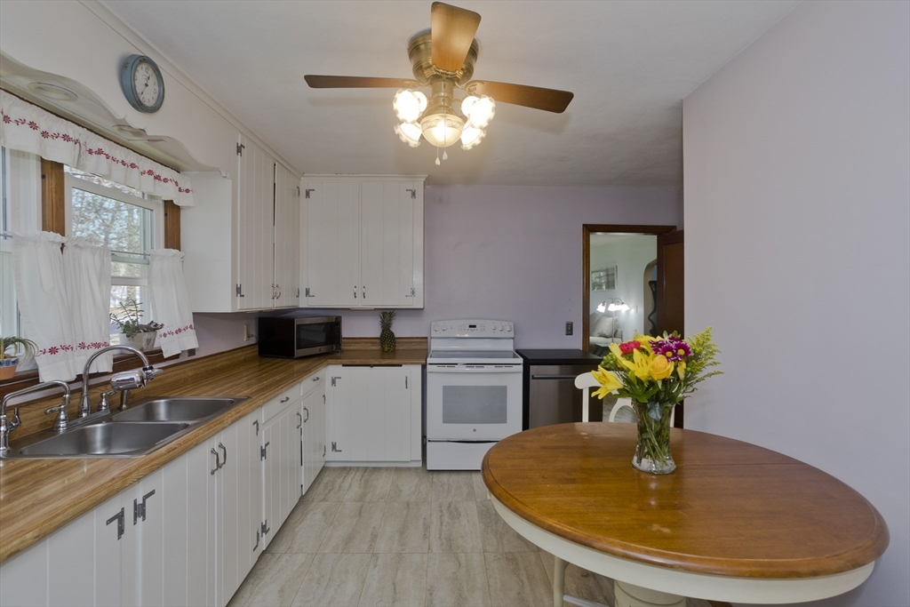 460 James Street Chicopee, MA 01020 - Photo 5 of 34 a kitchen with a white cabinet a sink dishwasher and a stove with wooden floor