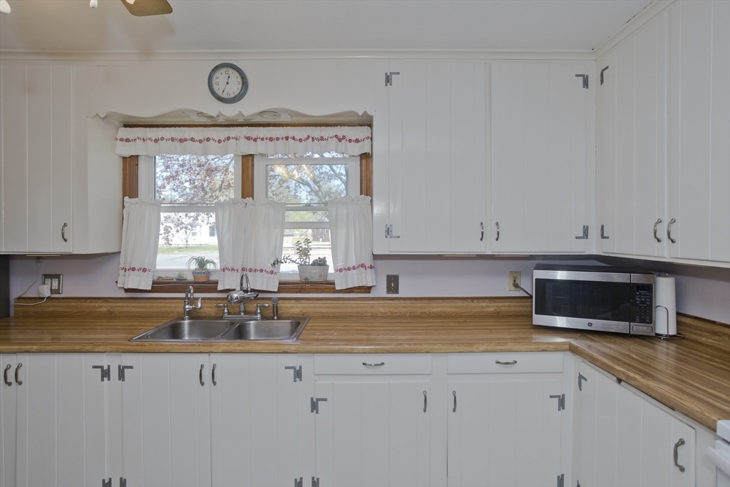 460 James Street Chicopee, MA 01020 - Photo 9 of 34 a kitchen with stainless steel appliances granite countertop a sink a stove and a granite counter tops