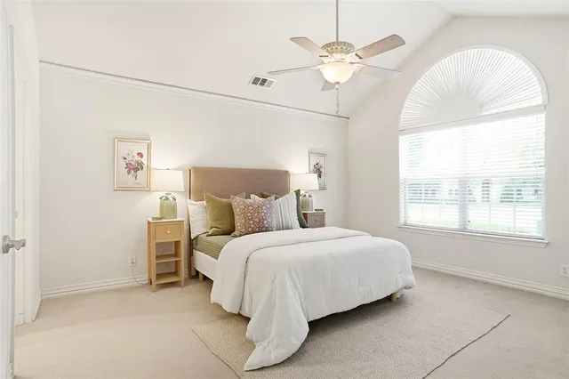 a bedroom with a bed and a chandelier