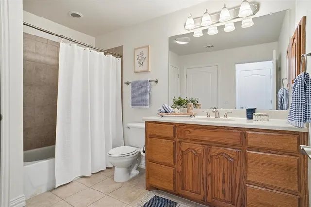 a spacious bathroom with a double vanity sink mirror and toilet