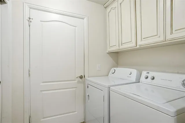 a view of storage and utility room with washer and dryer