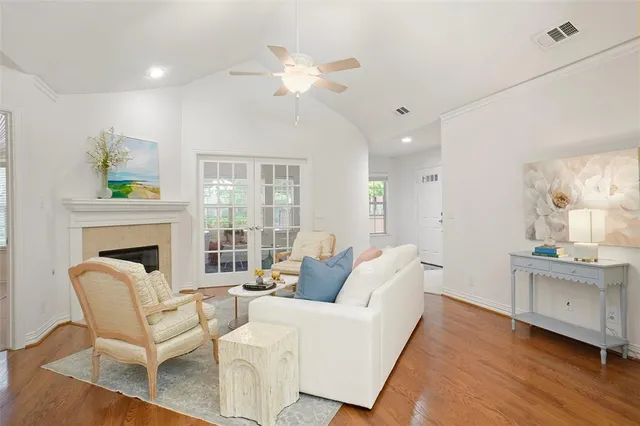 a living room with furniture a fireplace and a chandelier