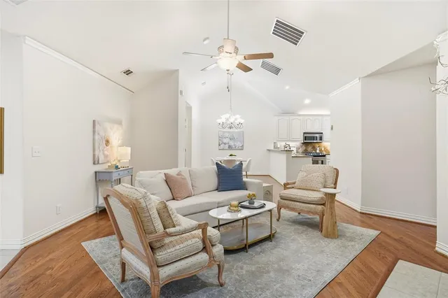 a living room with furniture and a chandelier
